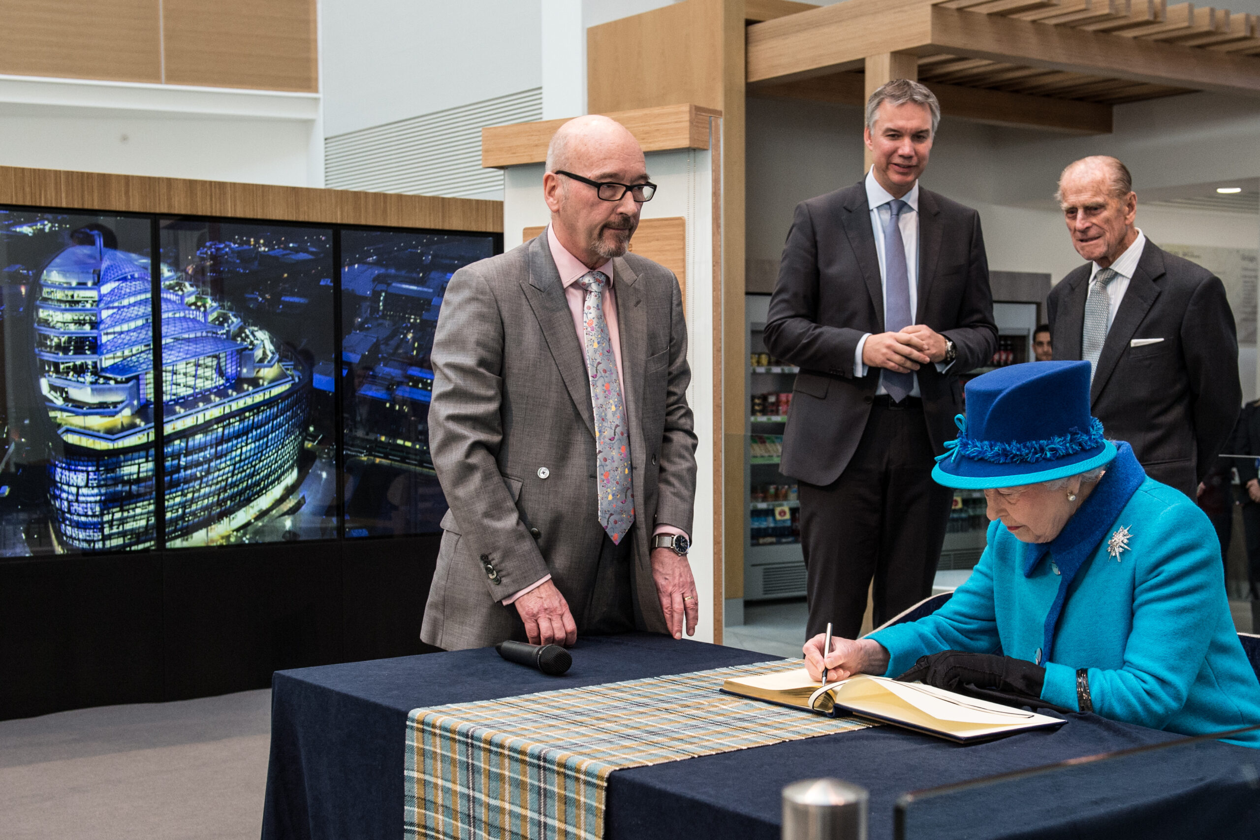 Queen Elizabeth II opening One Angel Square, with the MultiTouch wall in the background